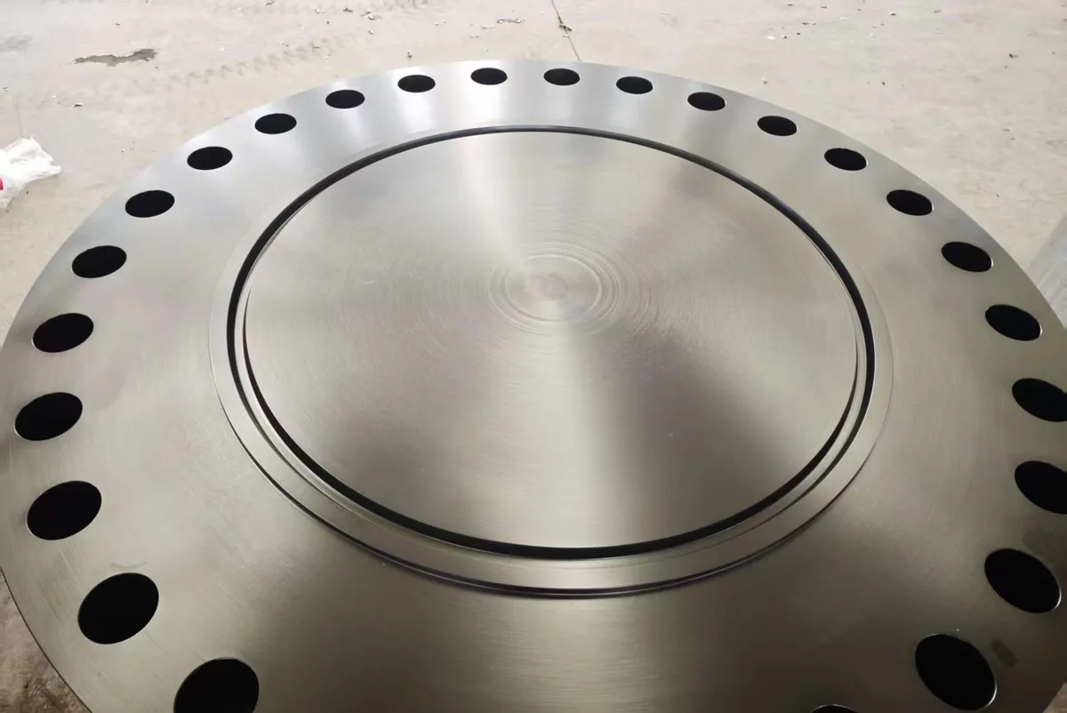 A large machined blind flange with a ring-type joint groove and a full circle of bolt holes